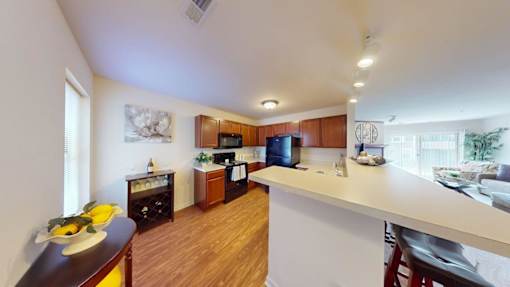 A kitchen with wooden floors and white walls.