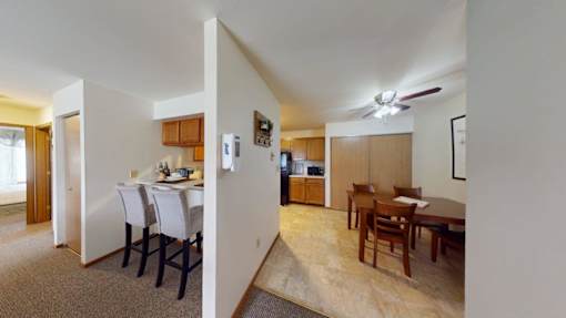 A room with a dining table and chairs is shown.