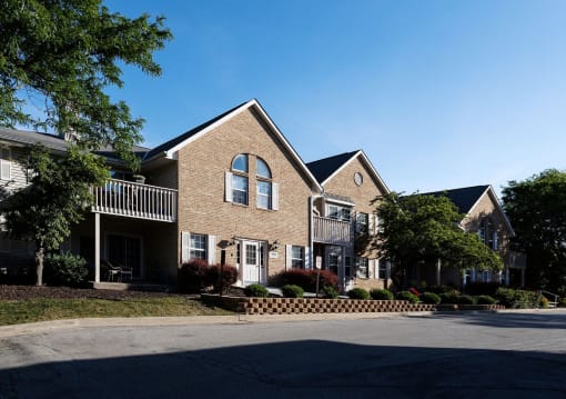 a brick house with a street in front of it