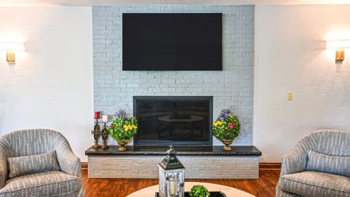 a living room with a fireplace and a flat screen tv on the wall