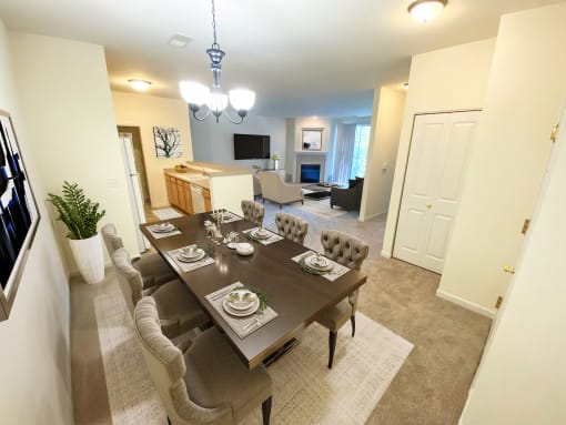 a dining room and living room with a table and chairs