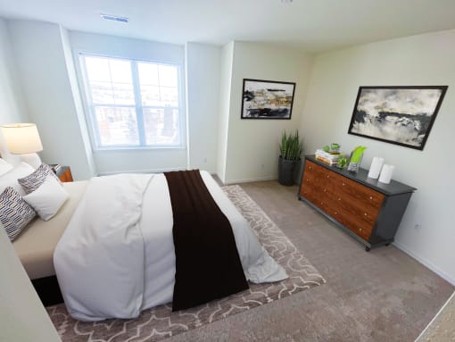 a bedroom with a large bed and a dresser