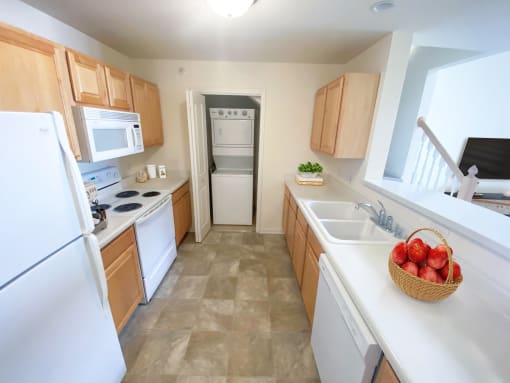 a kitchen with white appliances and wooden cabinets