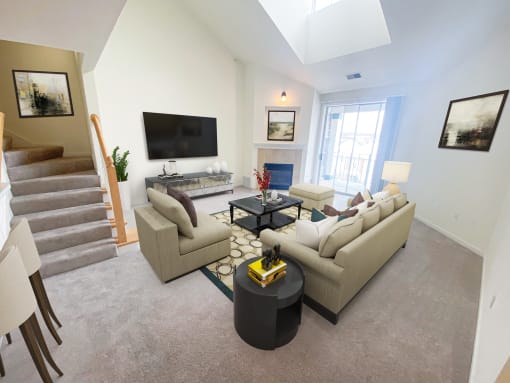 a living room with white walls and a vaulted ceiling