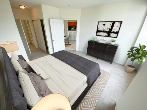 a bedroom with a large bed and a dresser