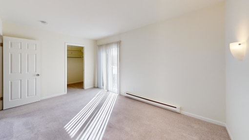 a living room and bedroom with a door to a closet