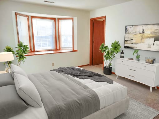 a bedroom with a bed and a large window