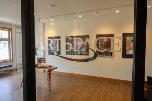 a view of an art gallery with paintings on the wall
