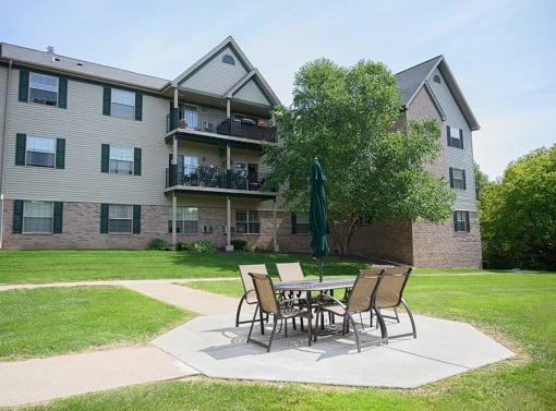 our apartments have a patio with a table and chairs