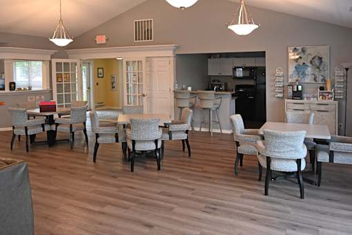 A dining room with a table and chairs.