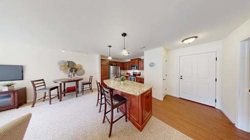 A kitchen with a dining table and chairs.