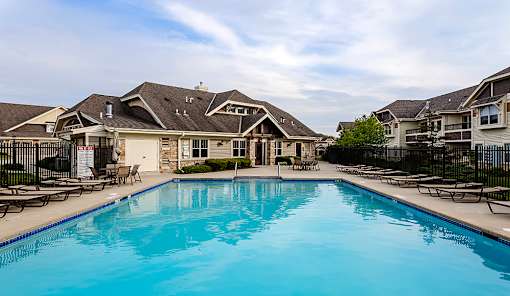 A swimming pool in front of a row of houses.