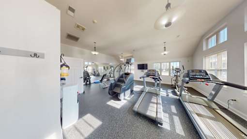 A spacious gym with treadmills and exercise equipment.
