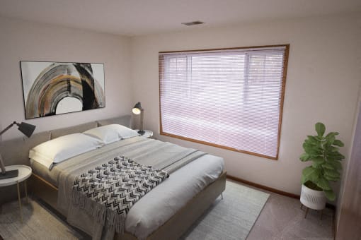 A bedroom with a large bed and a painting on the wall.
