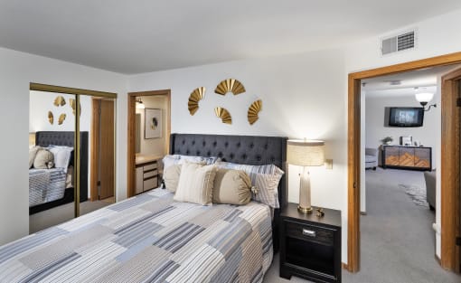 a bedroom with a bed and a mirror