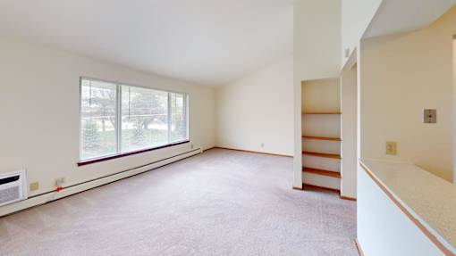 Empty room with a window and a staircase.