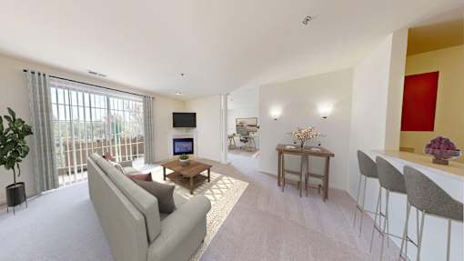 A living room with a grey couch, a wooden coffee table, and a flat screen TV.