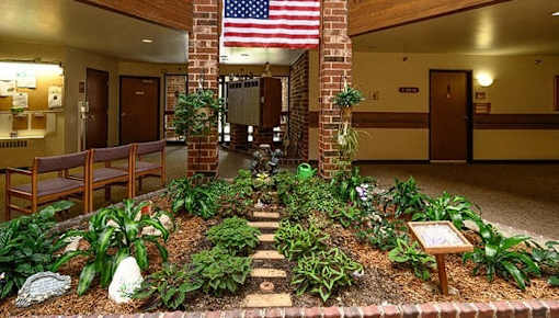 a courtyard with plants and a flag in a lobby