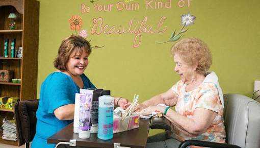 a woman sitting at a table talking to a patient