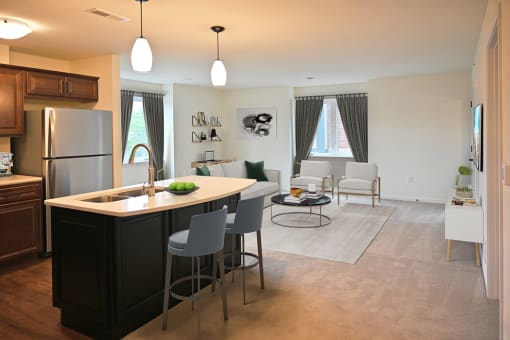a kitchen and living room with an island in the middle of it
