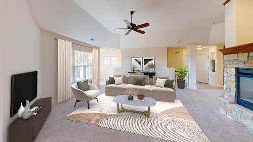 a living room with a couch and a ceiling fan