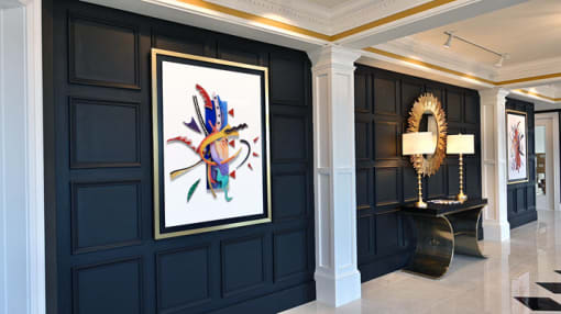 a room with a painting on the wall and a table