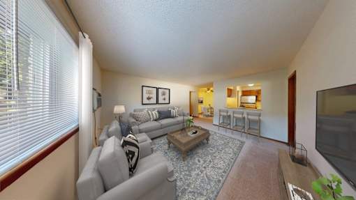 A living room with a grey couch and a coffee table.