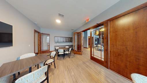 A room with a long table and chairs.