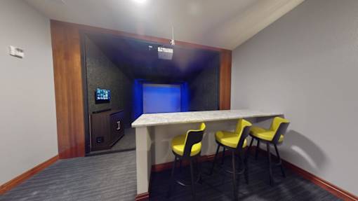 A conference room with a table and chairs.