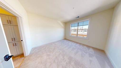 A room with a window and a door.