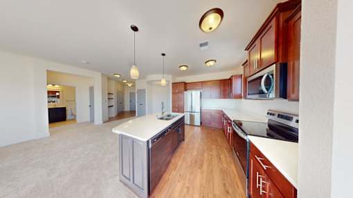 A kitchen with wooden cabinets and a white countertop.