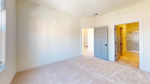 A room with a white wall and a carpeted floor.