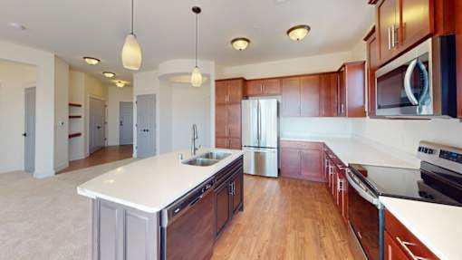 A kitchen with wooden cabinets and a white countertop.
