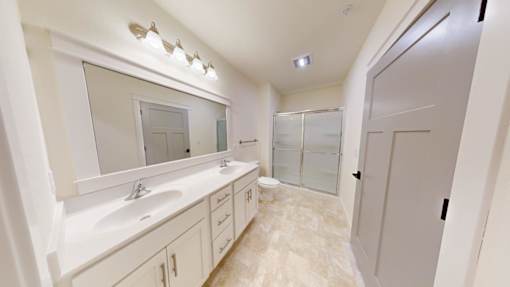 A bathroom with a sink, mirror, and toilet.
