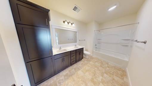 A bathroom with a sink, toilet, and bathtub.