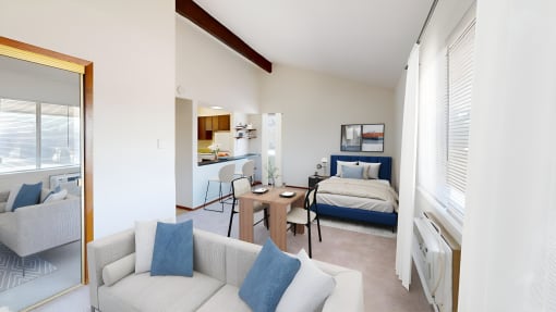 a living room with a couch and a chair and a bedroom with a bed
