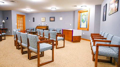 a seating area in a church with chairs and a podium