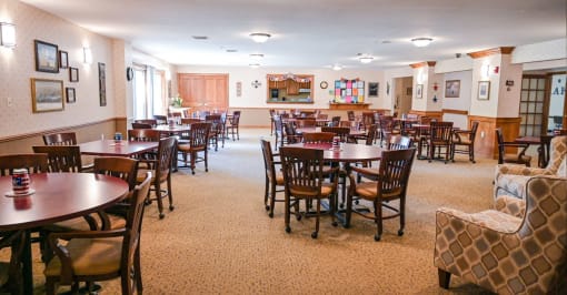 a dining room filled with tables and chairs in a restaurant
