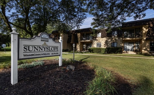 a sign that says sunnyside in front of a house