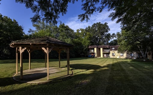a gazebo with a house in the background