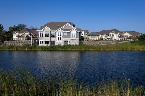 a house sits next to a body of water