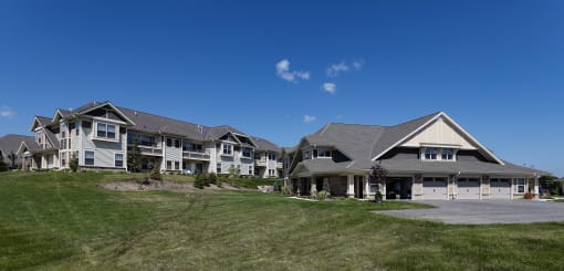 a group of houses on a hill with a blue sky