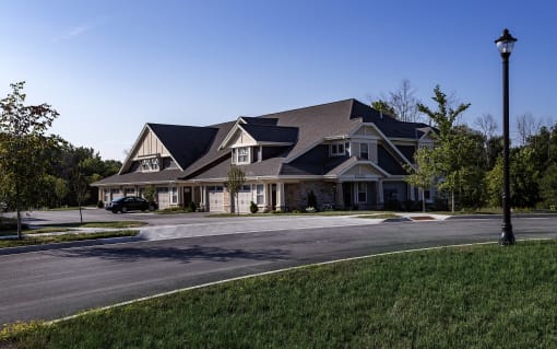 a large house on a street corner with a street light