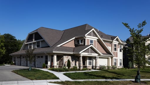 a large house with a large yard and sidewalk in front of it