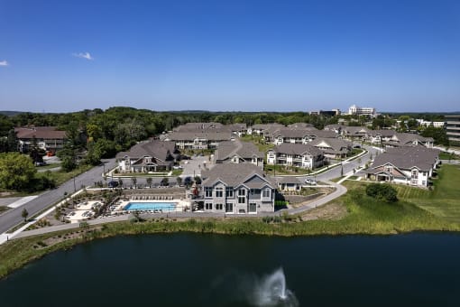 an aerial view of a large estate with a pool and a lake