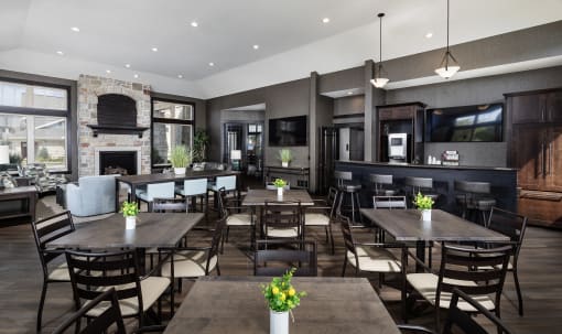 a large dining room with tables and chairs and a fireplace
