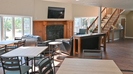 an open living room with tables and chairs and a fireplace