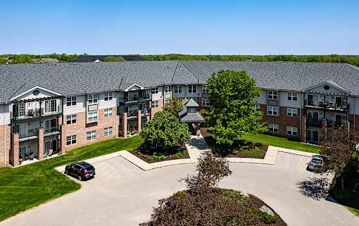 an aerial view of an apartment building with a parking lot