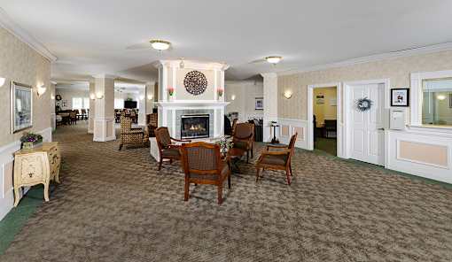 a large living room with a fireplace and a dining table