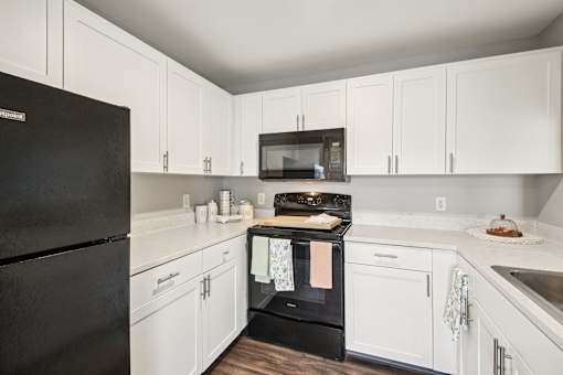 Kitchen With White Cabinets at CenterPointe Apartments & Townhomes, New York, 14424